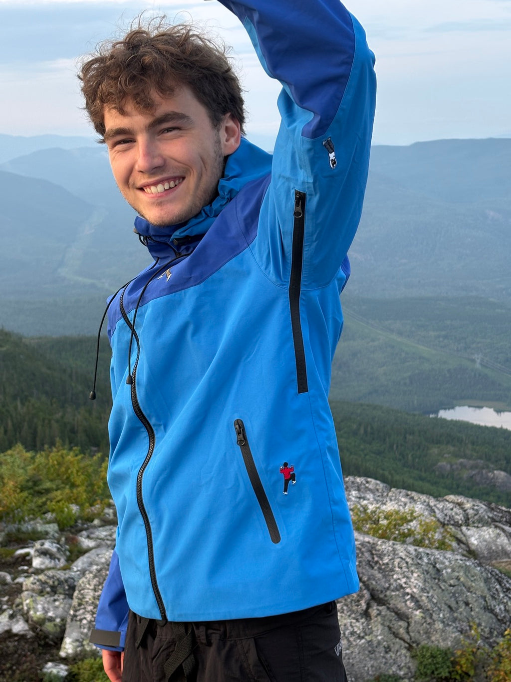 The Shell Jacket in blue on the summit